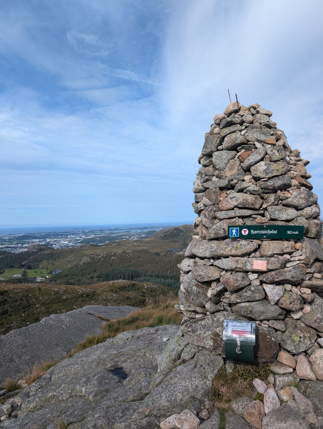 The summit cairn on Bjørndalsfjellet, marked 362 moh, overlooking Sandnes and the fjord